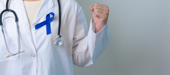 March Colorectal Cancer Awareness month, doctor with dark Blue Ribbon for supporting people living...