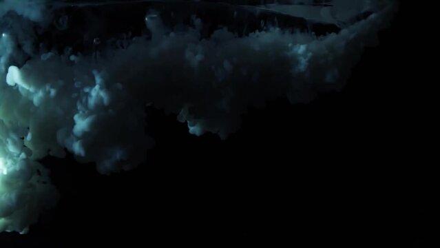 White paint drops from above mixing in water. Ink swirling underwater in slow motion. Cloud of ink isolated on black background. Abstract smoke explosion animation effect with particles. Close up view