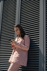 Fototapeta premium Confident Caucasian business woman walking near the office building 