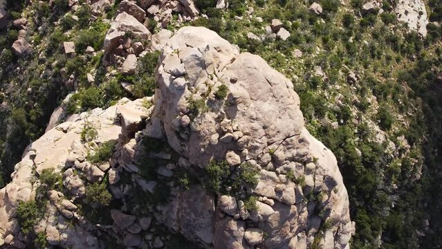 Aerial top down shot of rocks on top of mountain in scenic area of Taif - Nepal during sunny day - rising shot