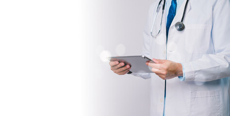 Doctor use technology, holding tablet, embodies intersection of medical professionalism and...