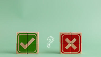 Tick mark and cross mark on a wooden cube. the decision between Yes or No choice symbol for...