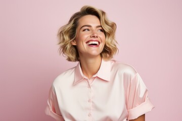 Portrait of a happy young woman in pink shirt on a pink background - Powered by Adobe