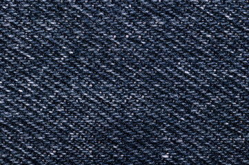 Denim surface, blue jeans fabric, front side, from above. Sturdy cotton warp-faced fabric. Type of...