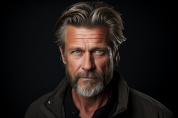 Portrait of a handsome mature man with gray beard and mustache. Studio shot.