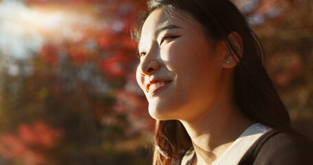 Outdoor, thinking and Asian woman with a smile, nature and forest with joy, daydreaming and...