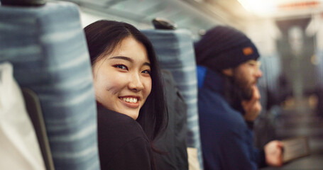 Smile, face and young Asian woman on a train for public transportation to work in the city. Happy,...