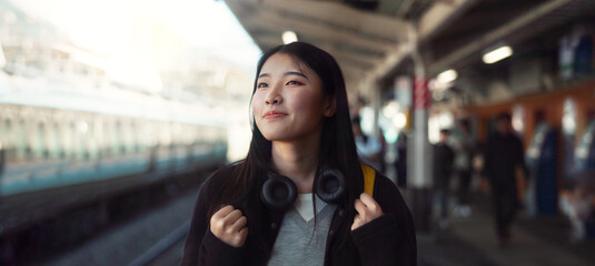 Asian, woman at train station for travel, commute or holiday with smile on face and freedom...
