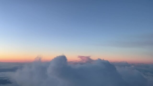 Aerial view of a cold winter sky before sunrise, shot from a jet cockpit, as seen by the pilots. 5000m high. A pilot&rsquo;s perspective.