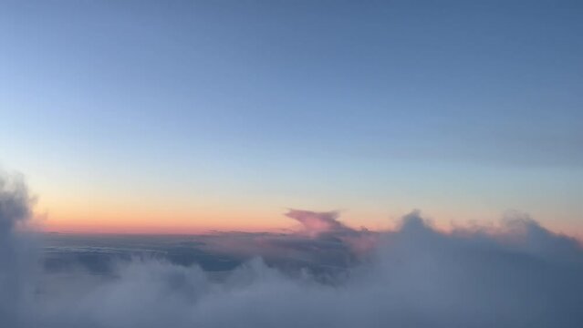 Overflying some clouds in a cold winter sky just before sunrise, as seen by the pilots of an airplane. 5000m high.  A real pilot&rsquo;s perspective