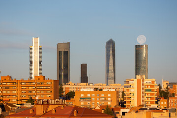 Fototapeta premium The moon over the four towers in the city of Madrid, Spain