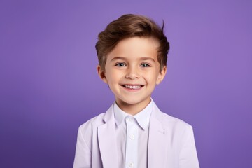 Portrait of a smiling little boy in a white shirt on a purple background
