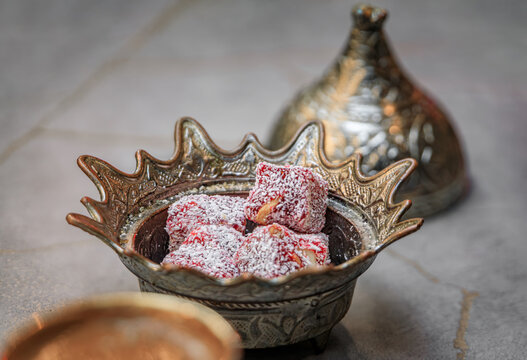 Ornate handmade silver bowl with traditional loukum or Turkish delight candy served with Turkish coffee at a restaurant, Sultanahmet, Istanbul, Turkey