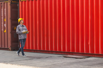 Japanese male smart worker working in container port cargo. Japan shipping logistics industry...