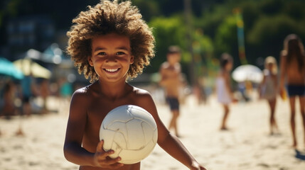 Happy African-American boy playing on the beach with a ball - obrazy, fototapety, plakaty
