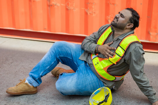 Heart attack chest pain expression. Hispanic indian fat male worker industry engineer staff accident fall down injury emergency need medical