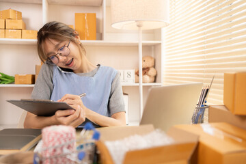 Sell products online, Young woman Multitasking: take orders from customers who call by phone, Young woman who has a lot of work and is very busy with work, Freelance working.