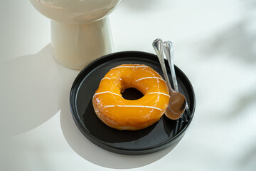 Orange Donut wood desk on wood desk on top view. As breakfast In a coffee shop at the cafe,during...