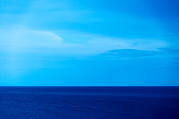 Fototapeta premium Landscape in blue with sea and cloudy dramatic sky