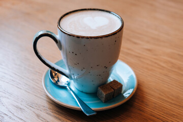 A cup of coffee on a wooden table. In the cafe.