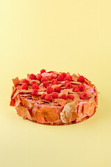 dessert with raspberries on a yellow background