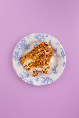 sponge cake with cream and nuts on a yellow background