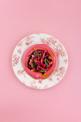 hummus with beetroot and onion in a plate