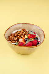 granola with yogurt and berries in a bowl. breakfast