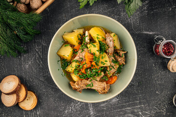 Portion of prepared stewed potatoes with meat