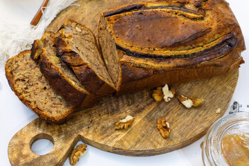 Homemade banana bread on wodden cutting board.