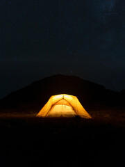 Yellow Illuminated Tent In The Mountains At Night