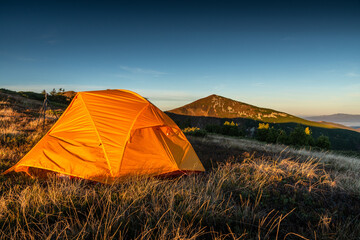 Campsite With a Yellow Tent In The Mountains, First Morning Light