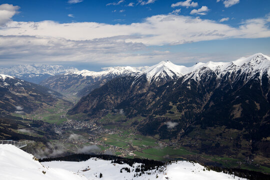 Chain of snow-capped Alpine mountains. Valley. View from top.