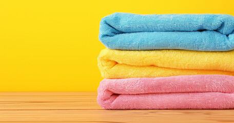 Obraz na płótnie Canvas Hotel towel, laundry and clean fabric background for laundromat business, detergent or hygiene. Colourful, neat and stacked fluffy textile for washing softener, cleaning service and eco friendly