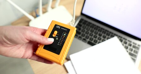 Hand technician with tester tool for test network cables closeup 4k movie slow motion. Diagnostics voltage and current of power electric line concept