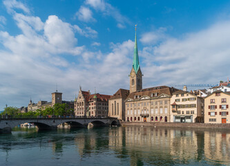 Fototapeta na wymiar Zurich, Switzerland. Cityscape with Fraumunster church and Munsterbrucke bridge over the Limmat River.