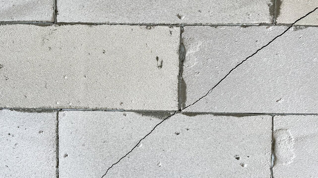 a crack in gas block wall, defective wall, cracked masonry, Cracks on wall, Low-quality brickwork, subsidence and cracking in wall