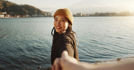 Happy, face and a couple holding hands at the beach for love, date or travel together for holiday....