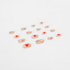 realistic set of colored false nails adhesive isolated on white background. top view. false nails...