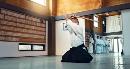 Aikido sword, mature sensei and man teaching class, self defense or combat technique. Martial arts,...