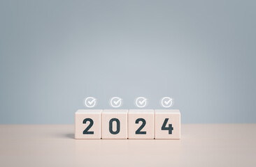 Set target successful project plan for the year 2024. Number 2024 on wooden blocks and correct sign...