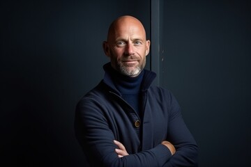 Portrait of a senior man with arms crossed looking at the camera