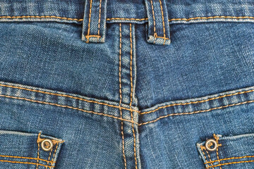 Fototapeta premium Jeans, denim close-up, seam with yellow threads.