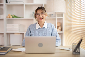 Woman typing in front of a laptop, Hand pressing laptop keyboard, Intention to work in the office.