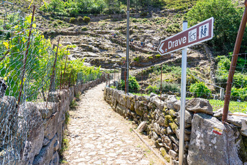 Pedestrian path from Aldeia de Regoufe to the uninhabited village of Drave, the most isolated in...