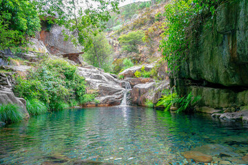 waterfall and natural pool in the uninhabited village of Drave, the most isolated village in...