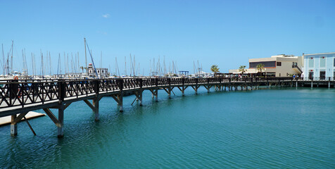 Fototapeta na wymiar Boardwalk at Marina Rubicon port at Playa Blanca in Canary Islands