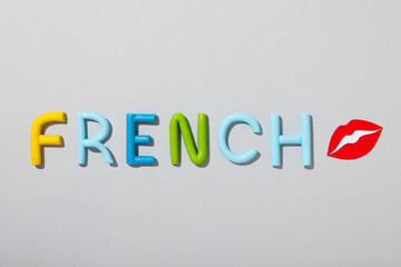 The word French on a gray background.