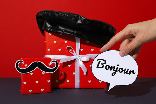 French symbols with a gift on a red background.