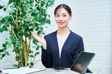 笑顔で話すスーツ姿の女性